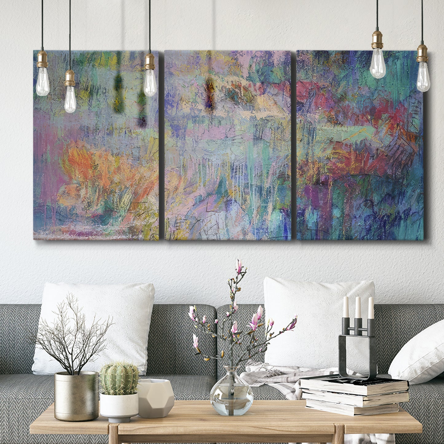 Three-panel canvas wall art featuring abstract evening landscape with depth, displayed in a modern living room above seating.