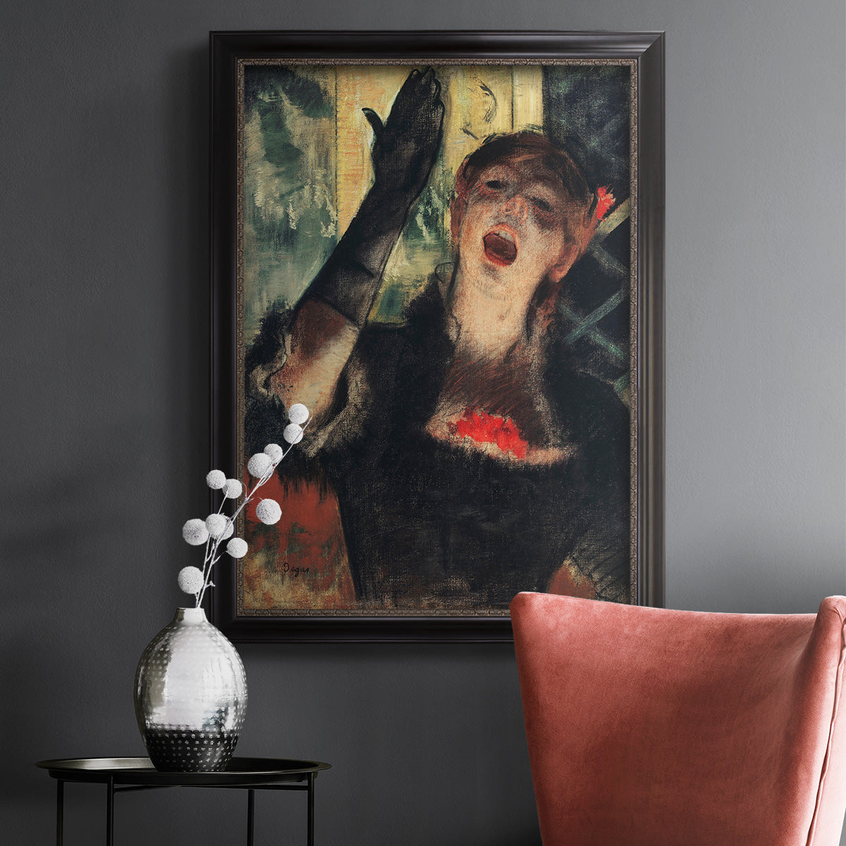 Impressionist portrait of a café singer by Edgar Degas in an ornate black frame with gilded inner detail displayed in a dark-toned interior setting.