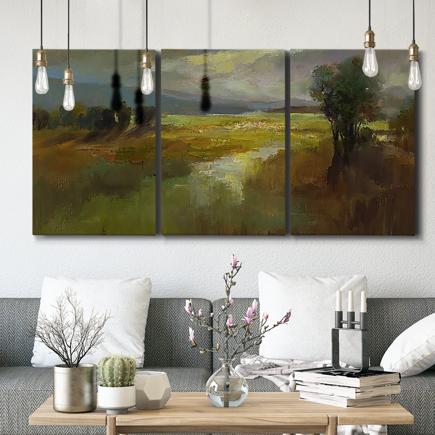 Three-panel canvas wall art featuring winding rural road through countryside, displayed in a modern living room above seating.