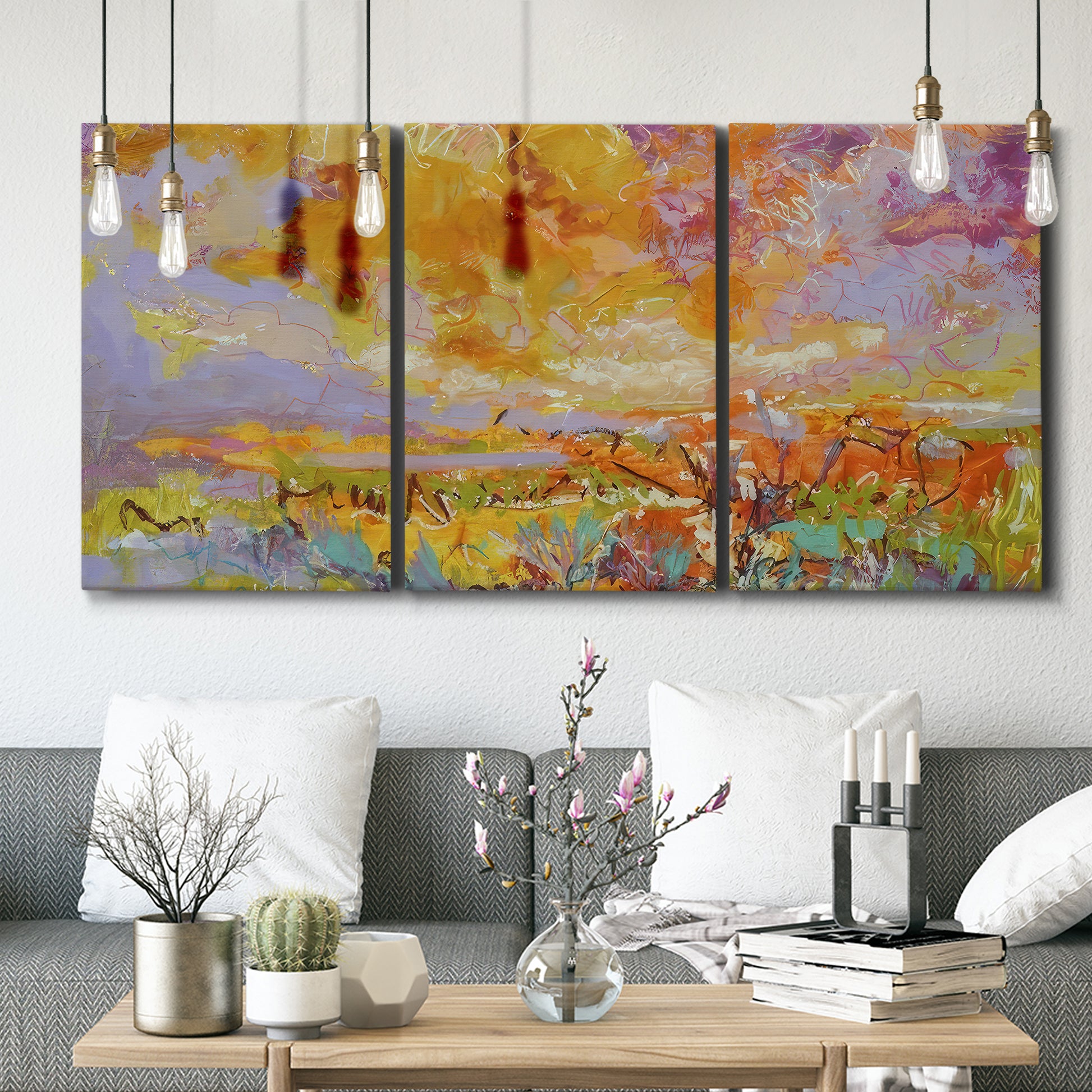 Three-panel canvas wall art featuring abstract meadow inspired color fields, displayed in a modern living room above seating.