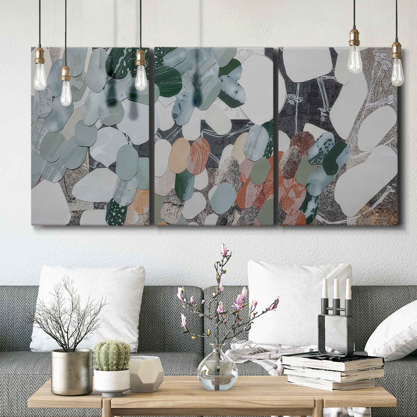 Three-panel canvas wall art featuring layered canyon inspired abstract forms, displayed in a modern living room above seating.