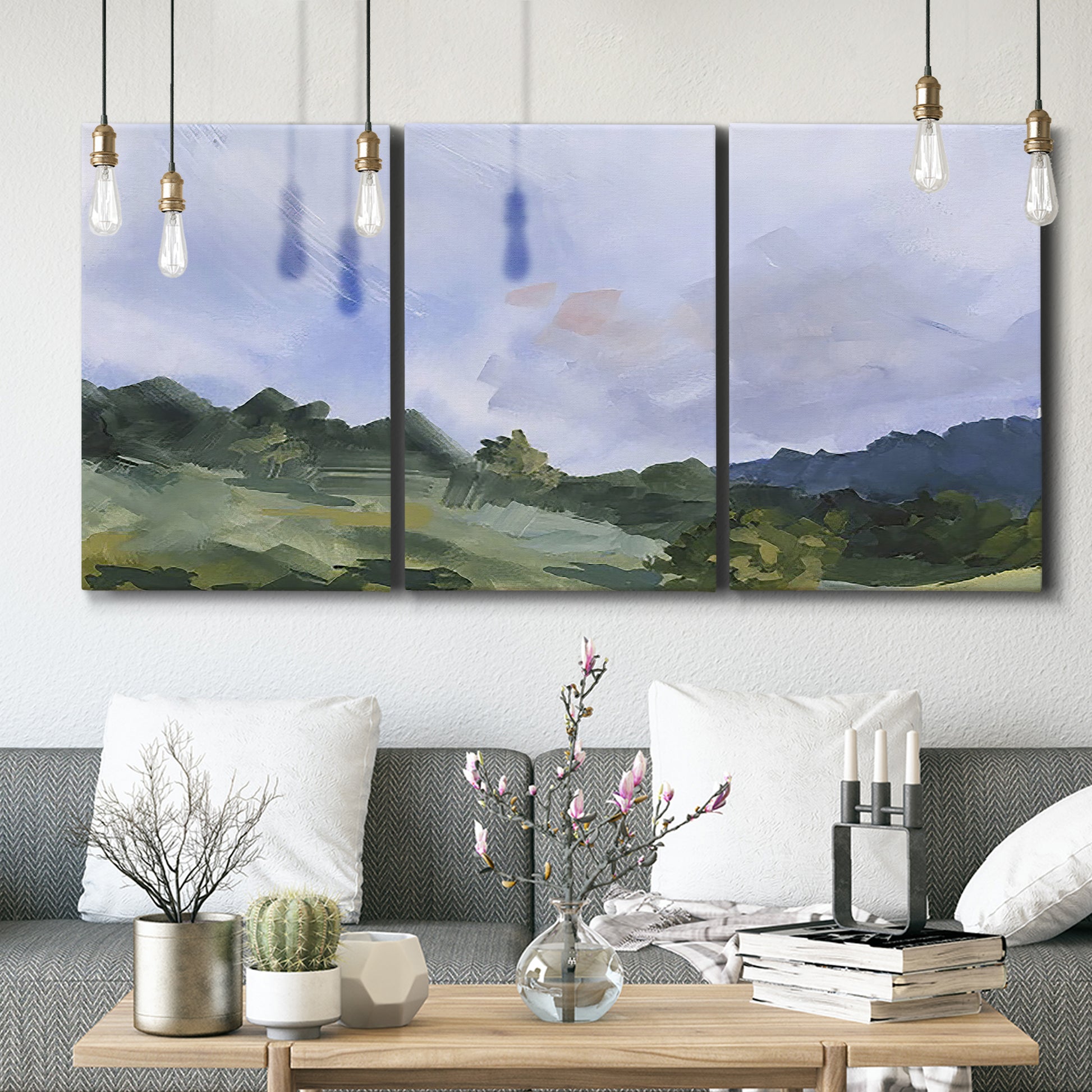 Three-panel canvas wall art featuring wide open pastoral horizon landscape, displayed in a modern living room above seating.