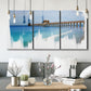 Three-panel canvas wall art featuring coastal pier extending over water, displayed in a modern living room above seating.