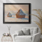 Impressionist winter haystack scene by Claude Monet in an ornate black frame with gilded inner detail displayed in a bright interior setting.