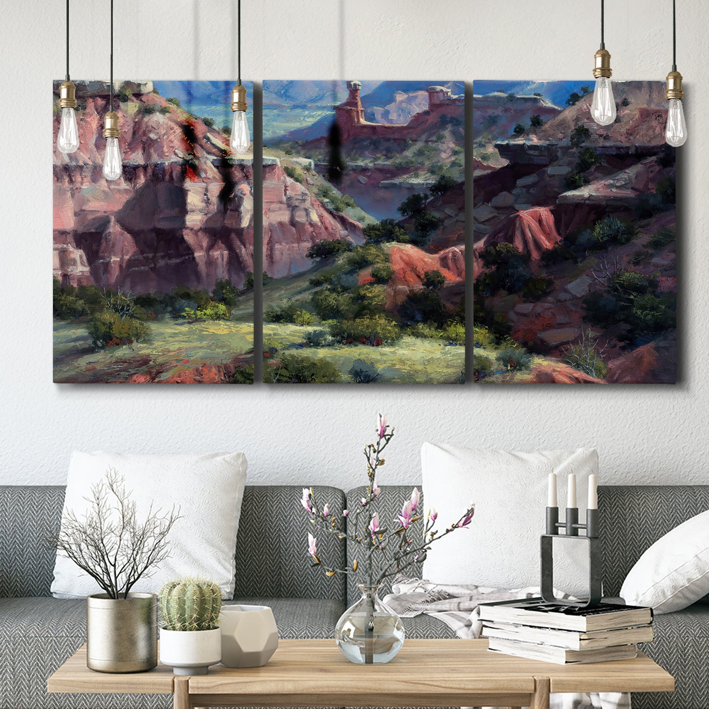 Three-panel canvas wall art featuring classic canyon landscape scene, displayed in a modern living room above seating.
