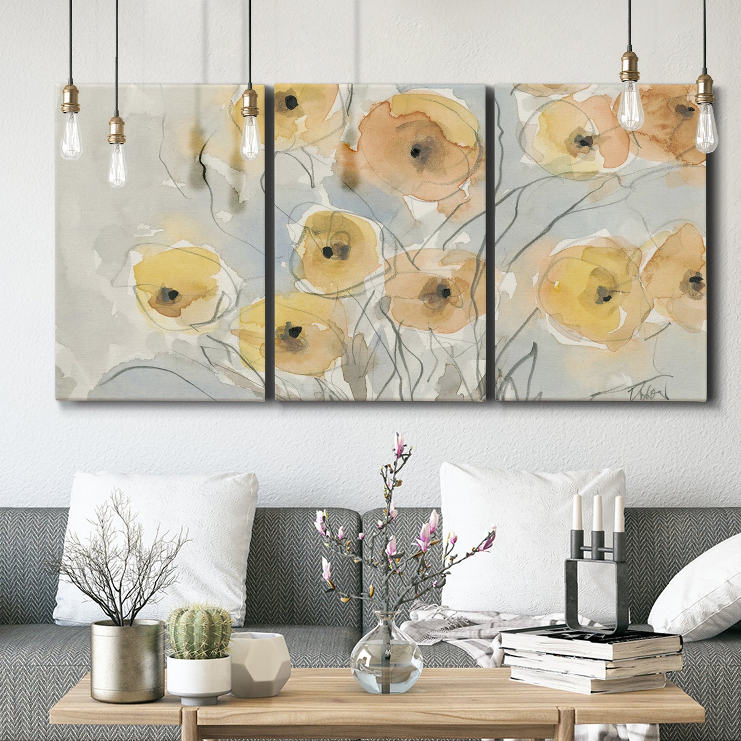 Three-panel canvas wall art featuring minimalist poppies at sunset, displayed in a modern living room above seating.