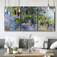 Three-panel canvas wall art featuring cascading purple wisteria blooms, displayed in a modern living room above seating.