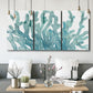 Three-panel canvas wall art featuring blue coral inspired watercolor, displayed in a modern living room above seating.