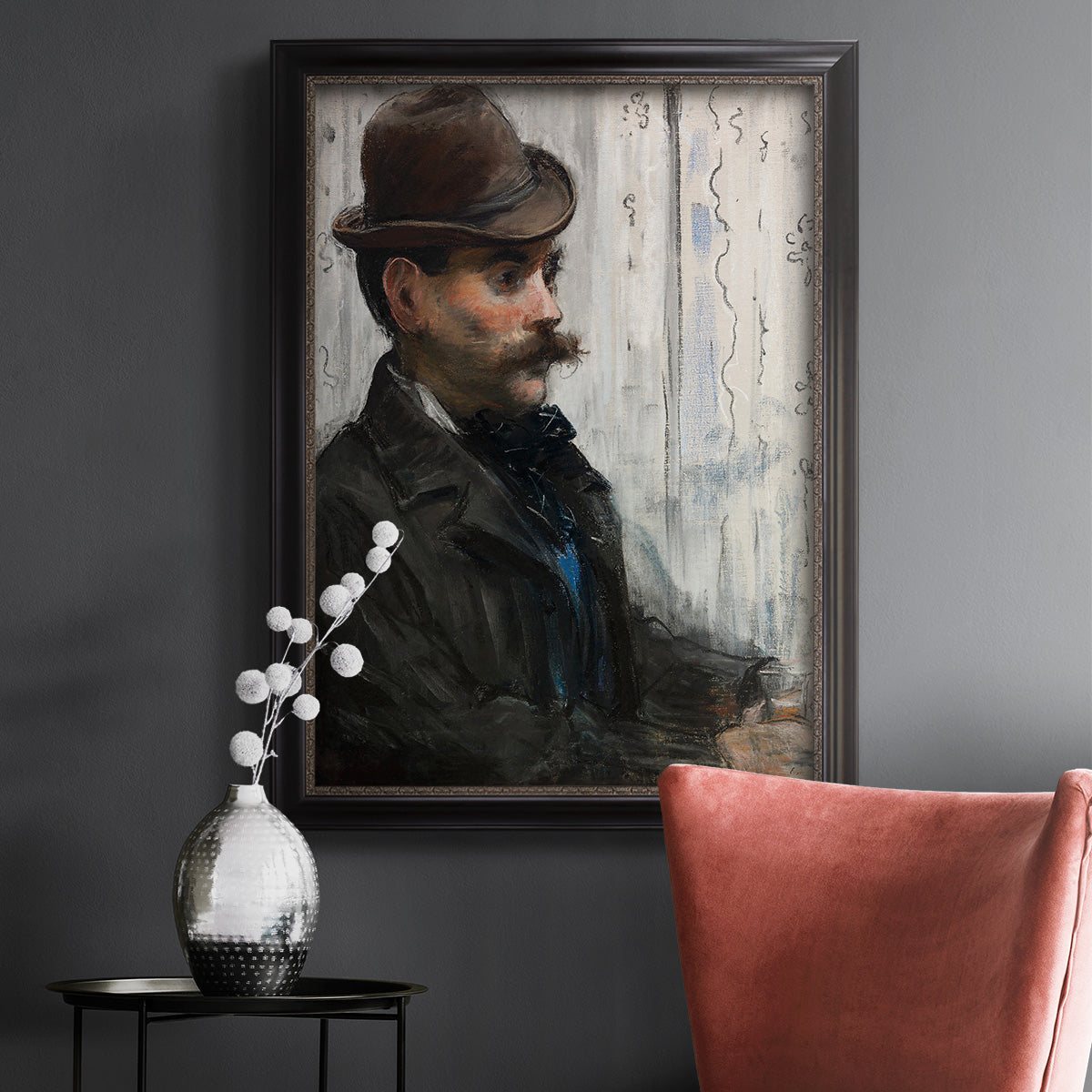 Impressionist portrait of a seated man by Édouard Manet in an ornate black frame with gilded inner detail displayed in a dark-toned interior setting.