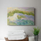 Serene coastal landscape with gentle waves and green hills under soft pastel skies at sunset