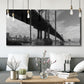 Three-panel canvas wall art featuring manhattan bridge industrial cityscape, displayed in a modern living room above seating.