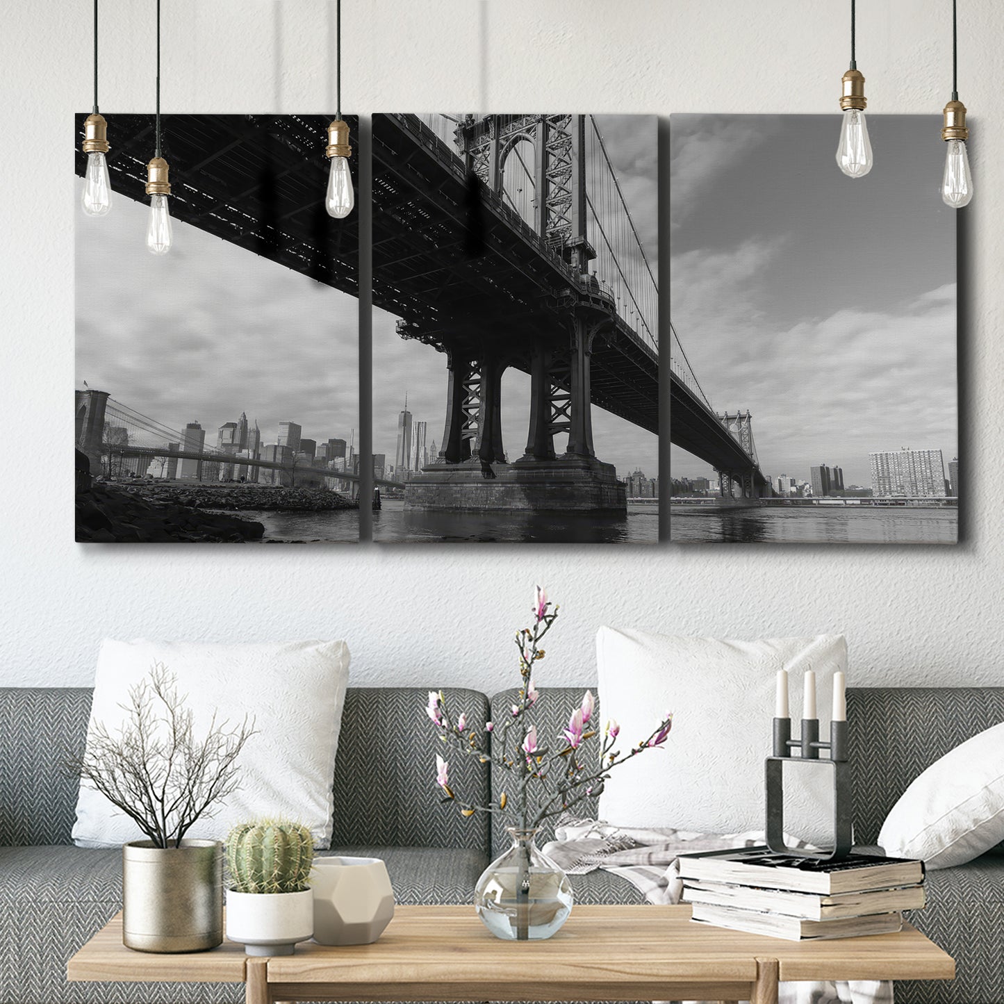 Three-panel canvas wall art featuring manhattan bridge industrial cityscape, displayed in a modern living room above seating.