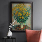 Impressionist floral painting of artichoke flowers by Claude Monet in an ornate black frame with gilded inner detail displayed in a dark-toned interior setting.