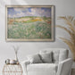 Impressionist countryside landscape near Auvers by Vincent van Gogh in an ornate champagne frame displayed in a bright interior setting.