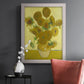 Impressionist sunflower still life painting by Vincent van Gogh in an ornate weathered white frame displayed in a dark-toned interior setting.