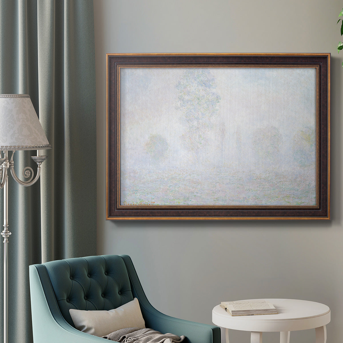 Impressionist atmospheric landscape in morning haze by Claude Monet in an ornate bronzed mahogany wood frame displayed in a bright interior setting.