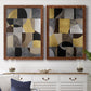Set of two maple barnwood framed canvas prints depicting a coordinated art pair of interlocking black gray cream and gold geometric sections rendered as structured modern abstracts above a dining room sideboard.