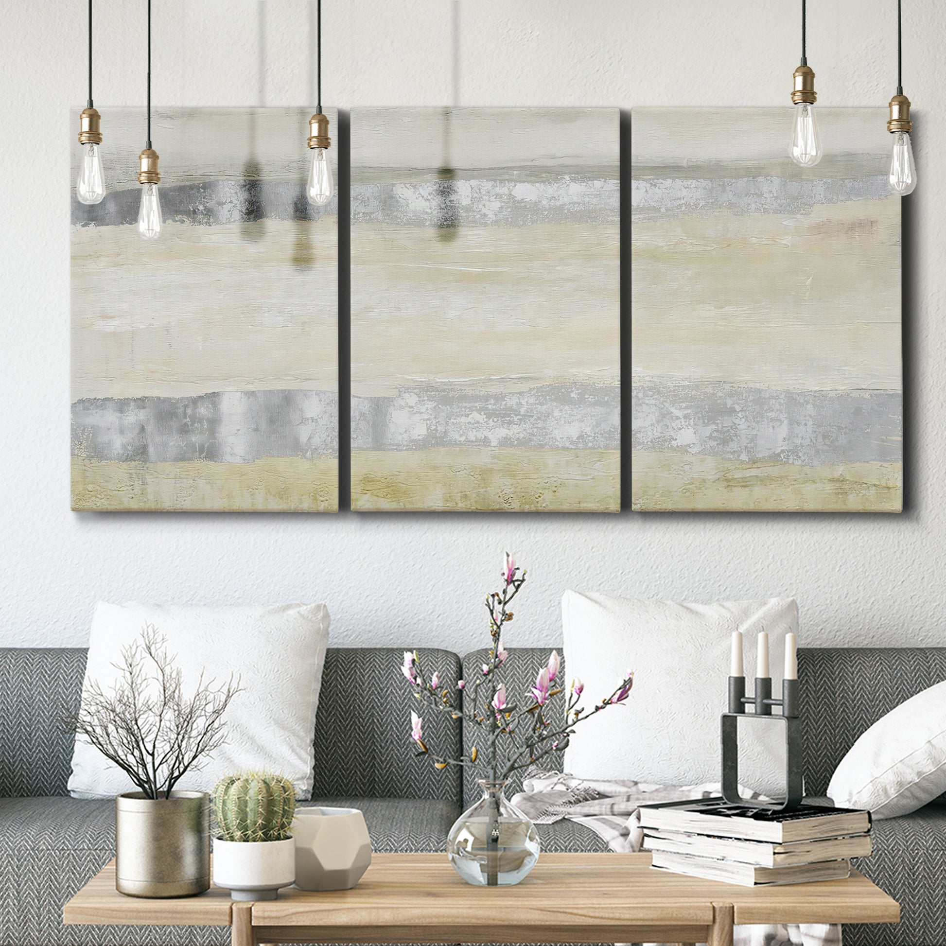 Three-panel canvas wall art featuring minimal abstract storm movement, displayed in a modern living room above seating.