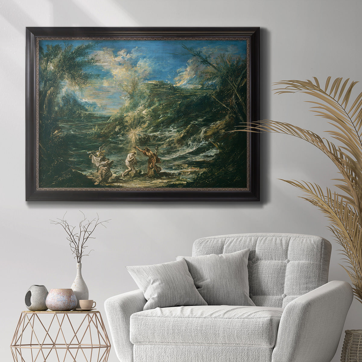 Religious landscape depicting the baptism of Christ by Alessandro Magnasco in an ornate black frame with gilded inner detail displayed in a bright interior setting.