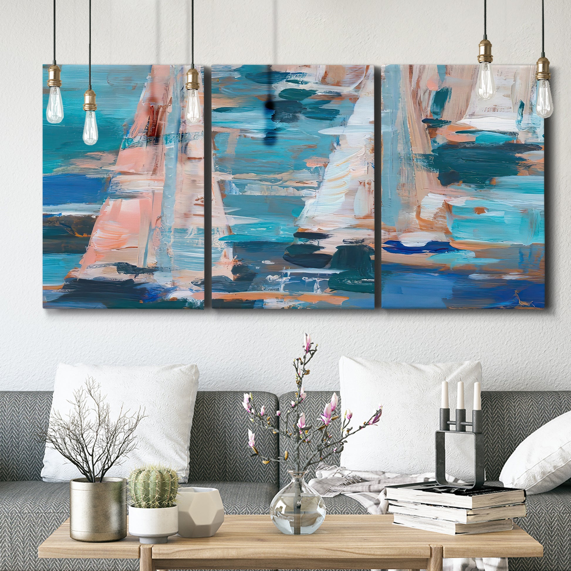 Three-panel canvas wall art featuring graphic pop style sailboats, displayed in a modern living room above seating.