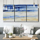 Three-panel canvas wall art featuring turbulent abstract ocean wave motion, displayed in a modern living room above seating.