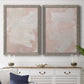 Set of two gray barnwood framed canvas prints depicting a coordinated art pair of soft blush and white painterly fields rendered as minimalist color-field abstracts above a dining room sideboard.