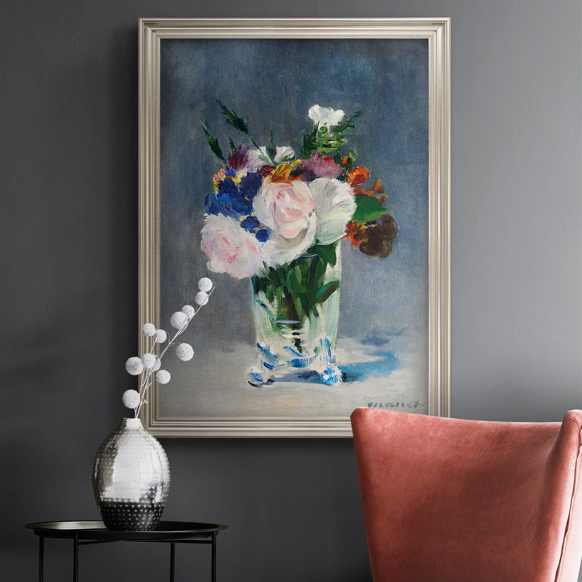 Impressionist floral still life painting by Claude Monet in an ornate champagne frame displayed in a dark-toned interior setting.