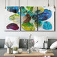 Three-panel canvas wall art featuring expressive abstract color interpretations, displayed in a modern living room above seating.