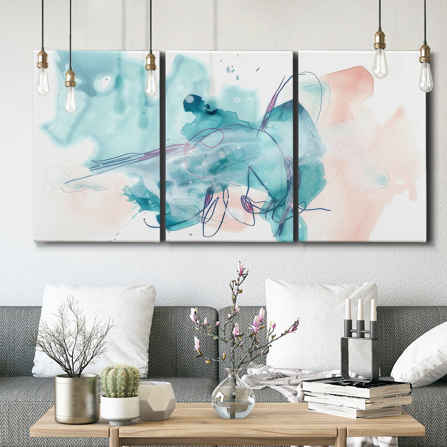 Three-panel canvas wall art featuring soft abstract watercolor forms, displayed in a modern living room above seating.