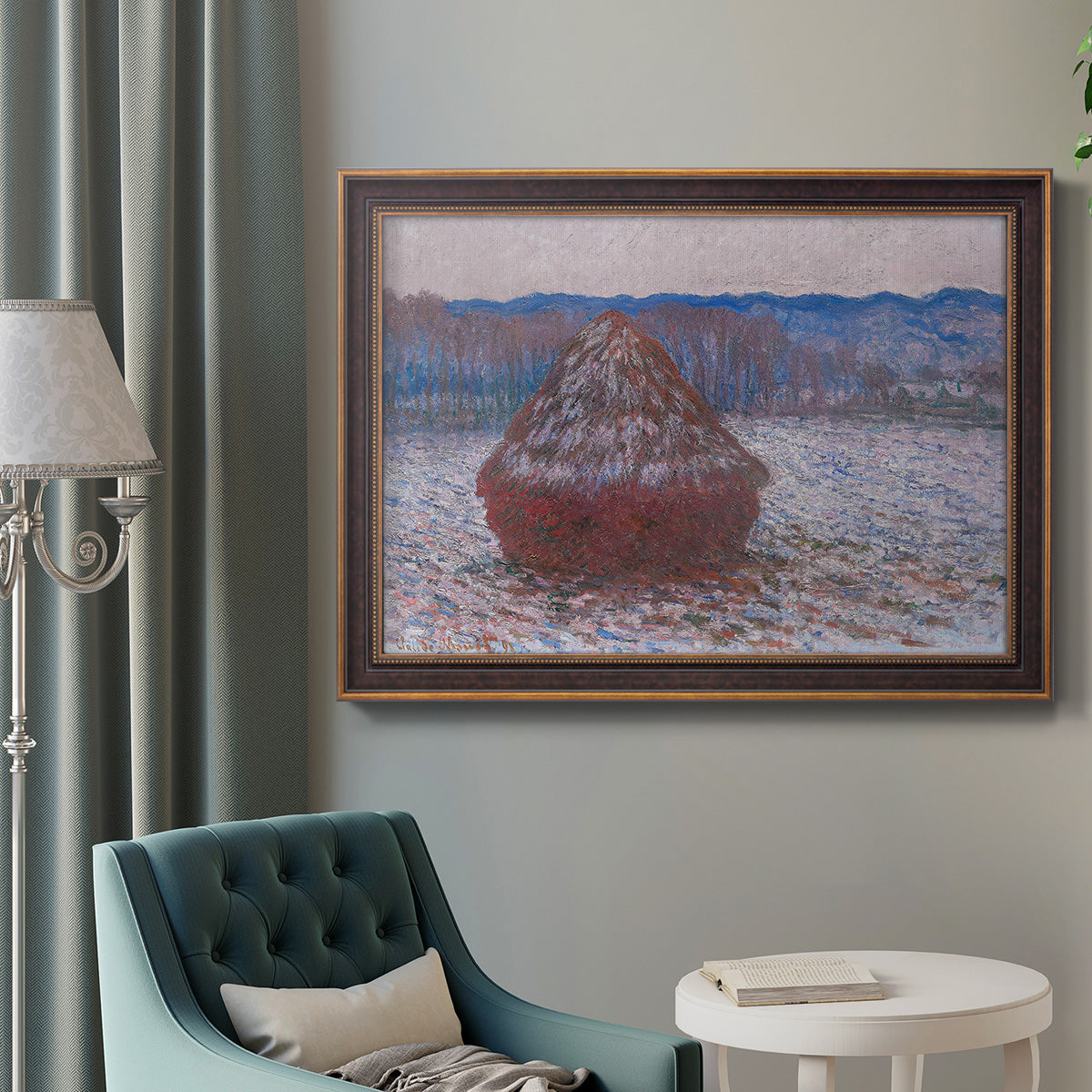 Impressionist single haystack landscape by Claude Monet in an ornate bronzed mahogany wood frame displayed in a bright interior setting.