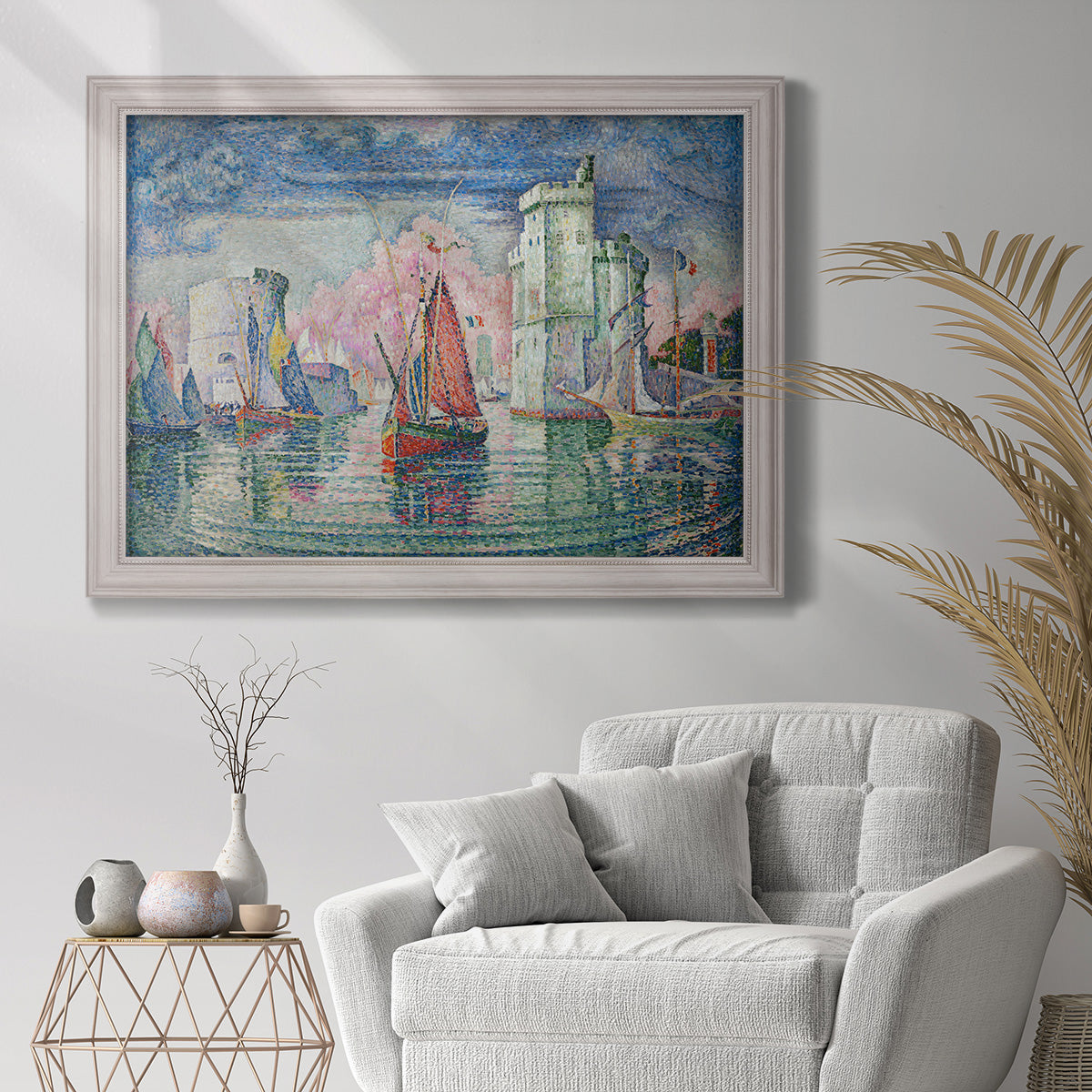 Impressionist harbor scene by Paul Signac in an ornate weathered white frame displayed in a bright interior setting.