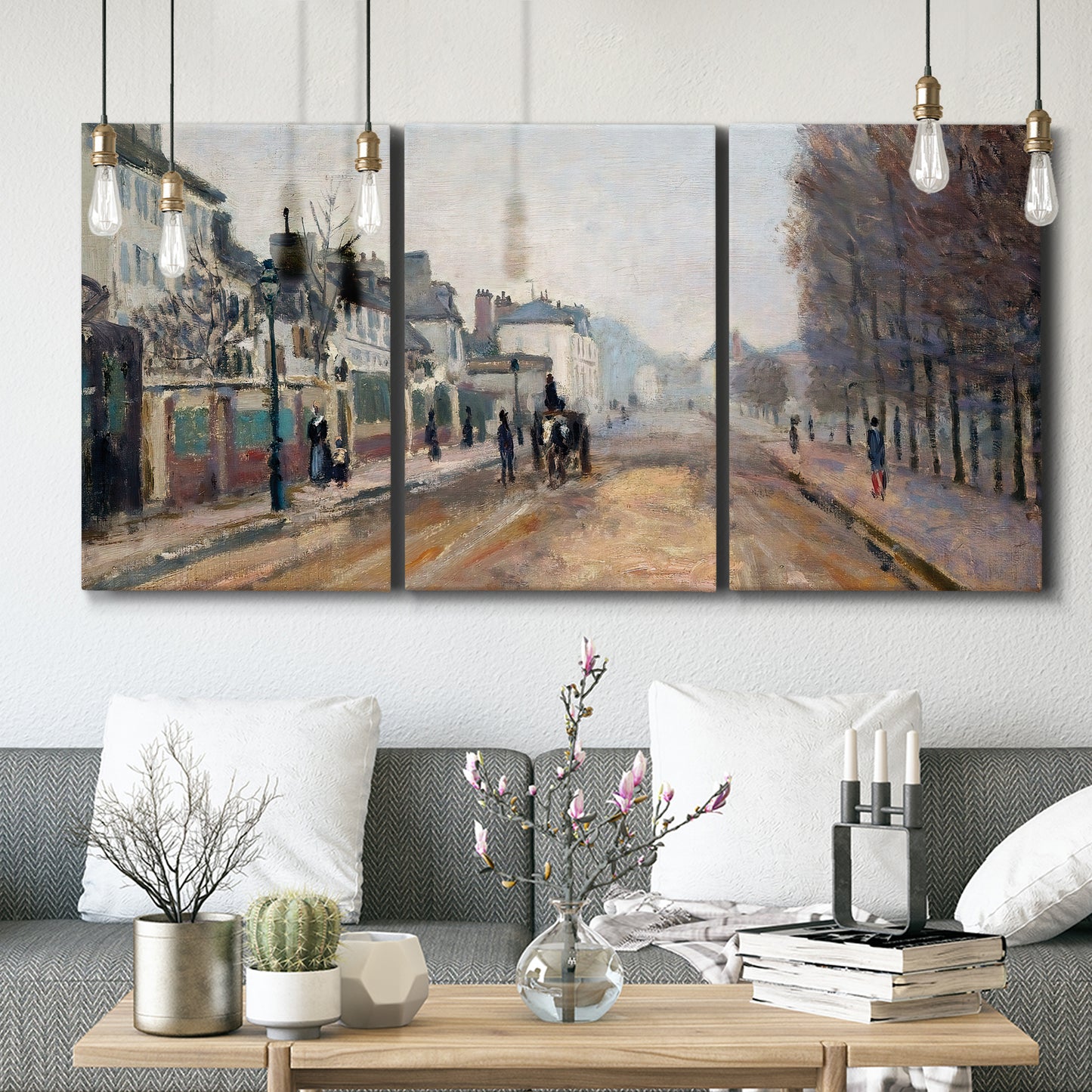 Three-panel canvas wall art featuring tree lined boulevard in town, displayed in a modern living room above seating.