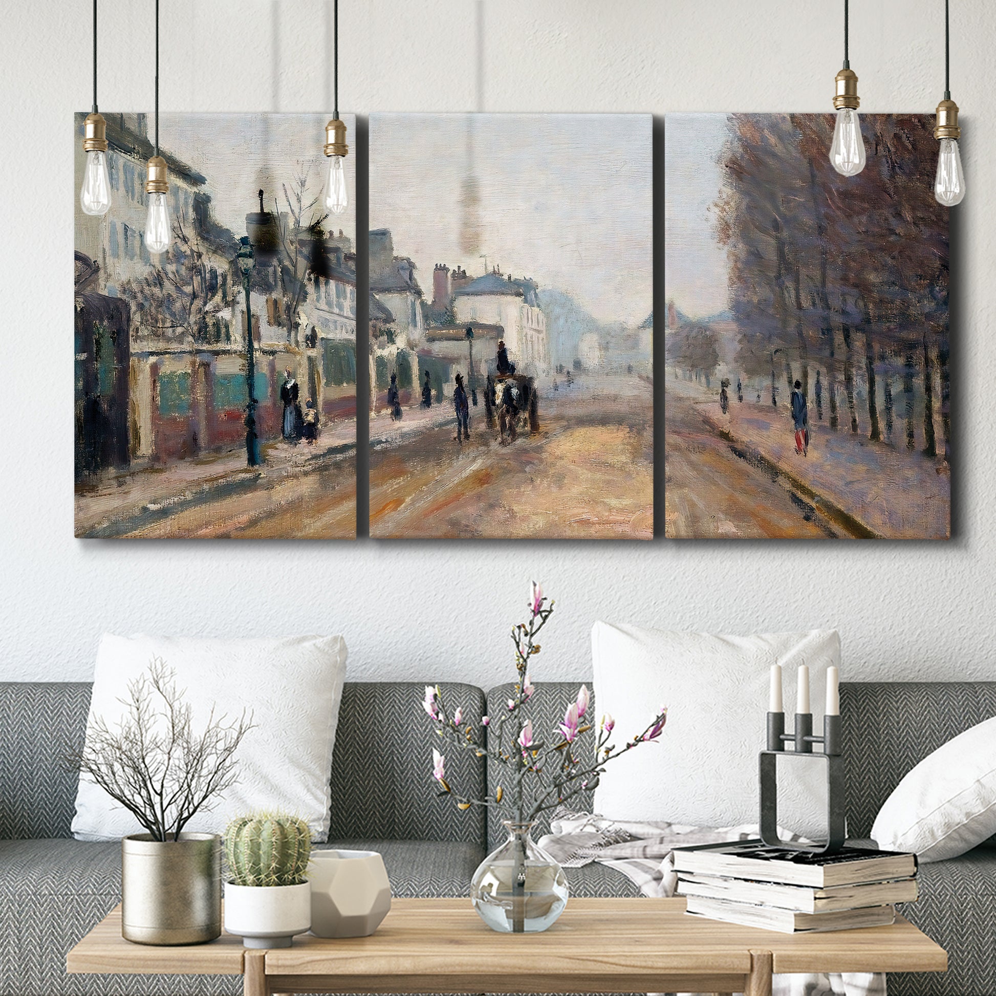 Three-panel canvas wall art featuring tree lined boulevard in town, displayed in a modern living room above seating.