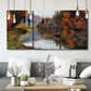 Three-panel canvas wall art featuring rowboat on quiet river bend, displayed in a modern living room above seating.