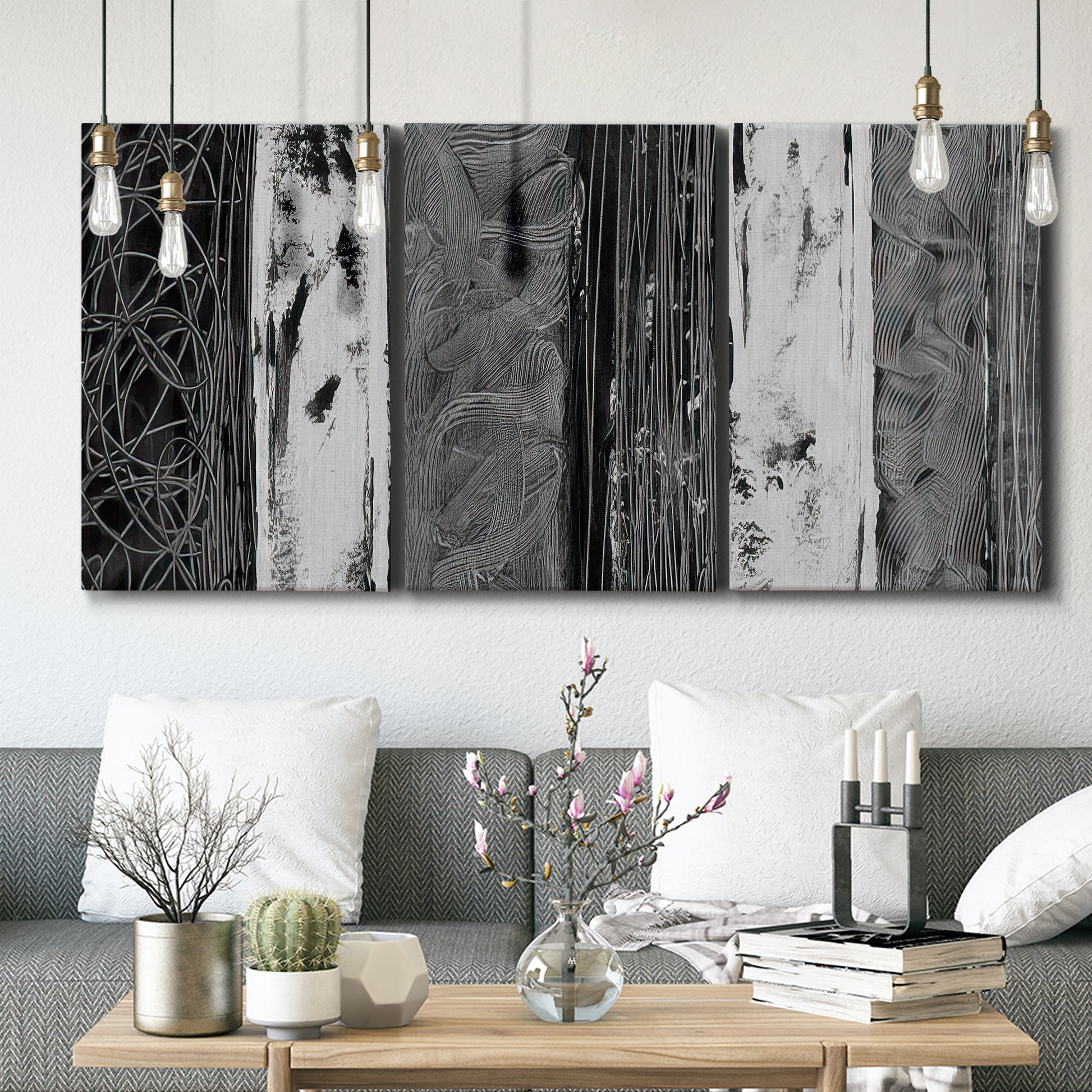 Three-panel canvas wall art featuring brushed metallic abstract textures, displayed in a modern living room above seating.