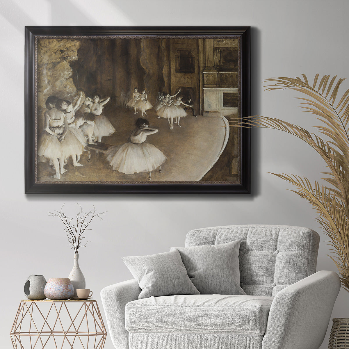 Impressionist ballet rehearsal scene by Edgar Degas in an ornate black frame with gilded inner detail displayed in a bright interior setting.