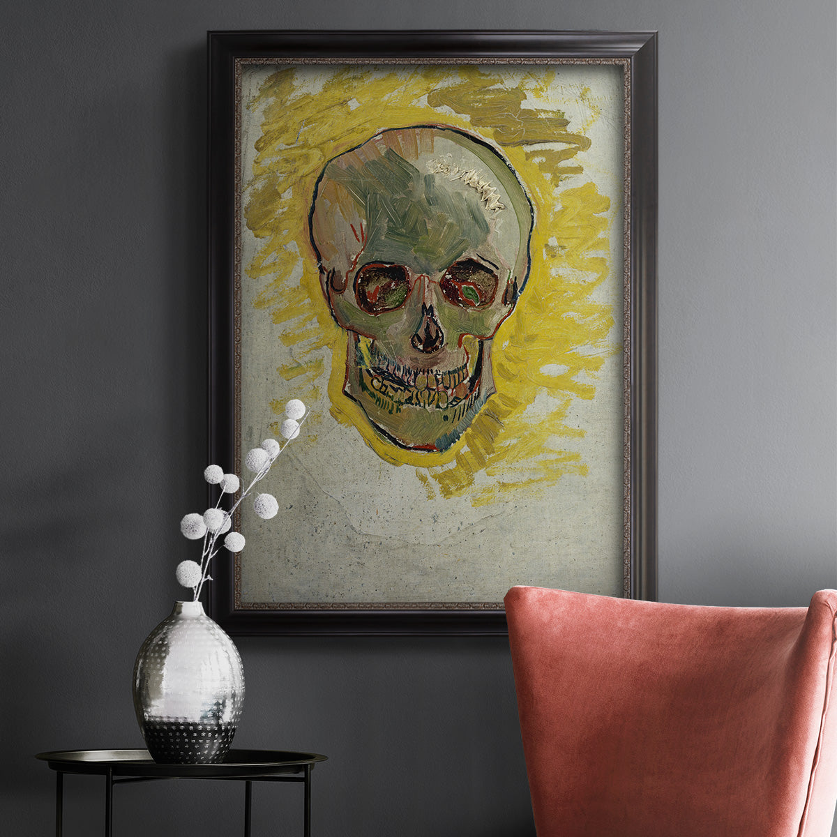 Expressive skull study painting by Vincent van Gogh in an ornate black frame with gilded inner detail displayed in a dark-toned interior setting.