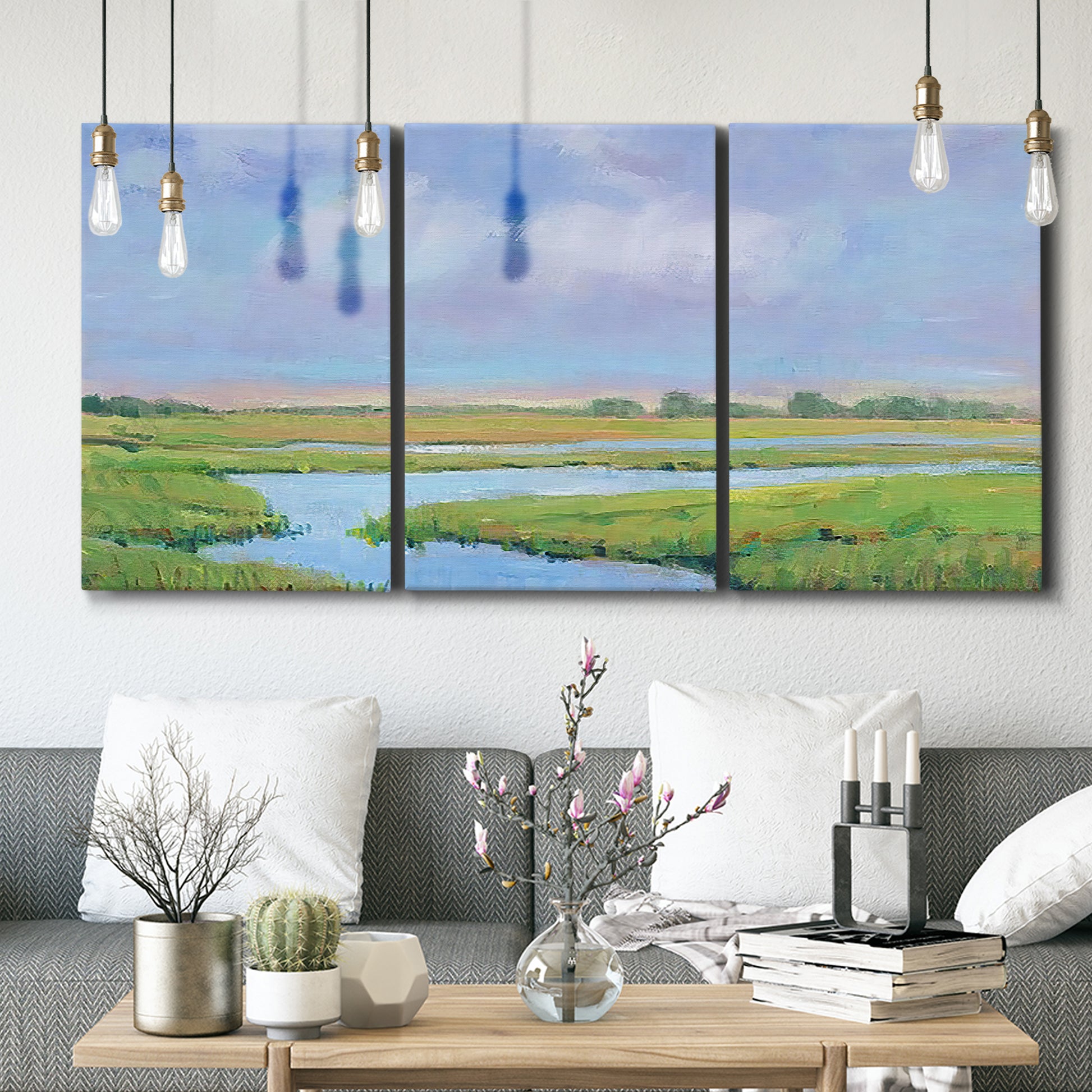 Three-panel canvas wall art featuring summer marshland with tall grasses, displayed in a modern living room above seating.