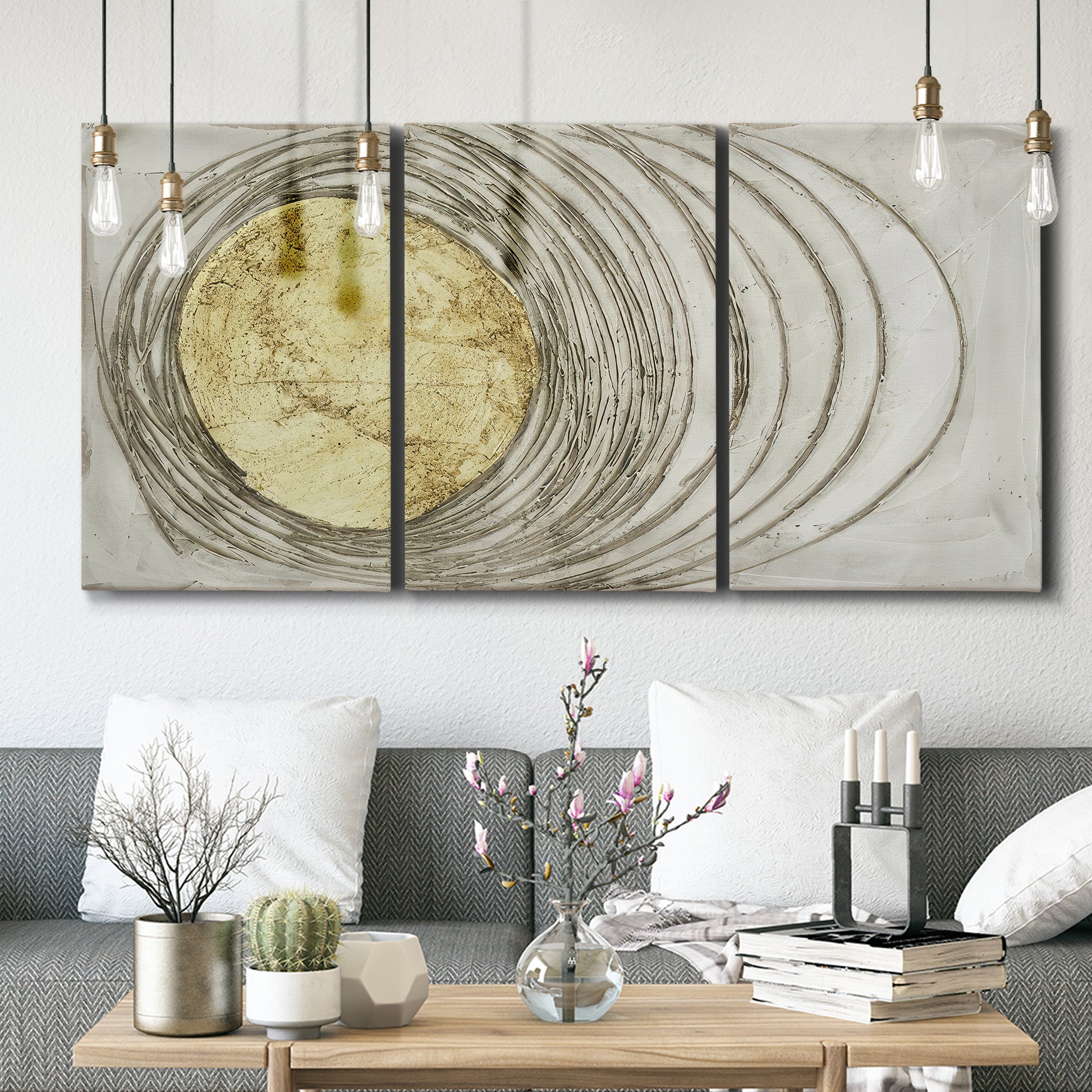 Three-panel canvas wall art featuring circular abstract energy forms, displayed in a modern living room above seating.