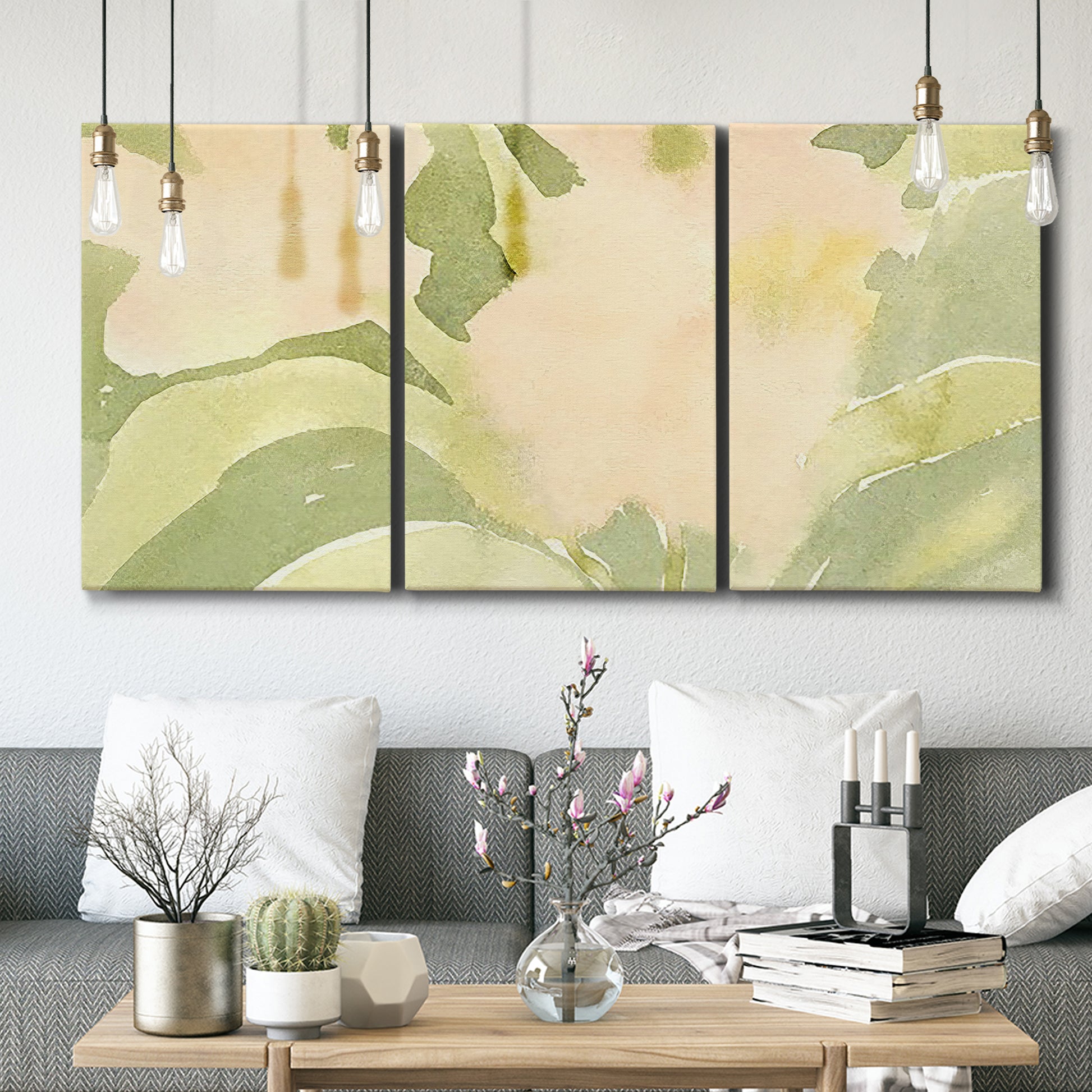 Three-panel canvas wall art featuring minimal verdant floral abstraction, displayed in a modern living room above seating.
