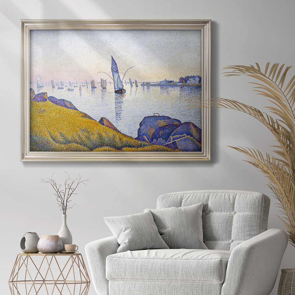 Impressionist coastal harbor at dusk by Paul Signac in an ornate champagne frame displayed in a bright interior setting.