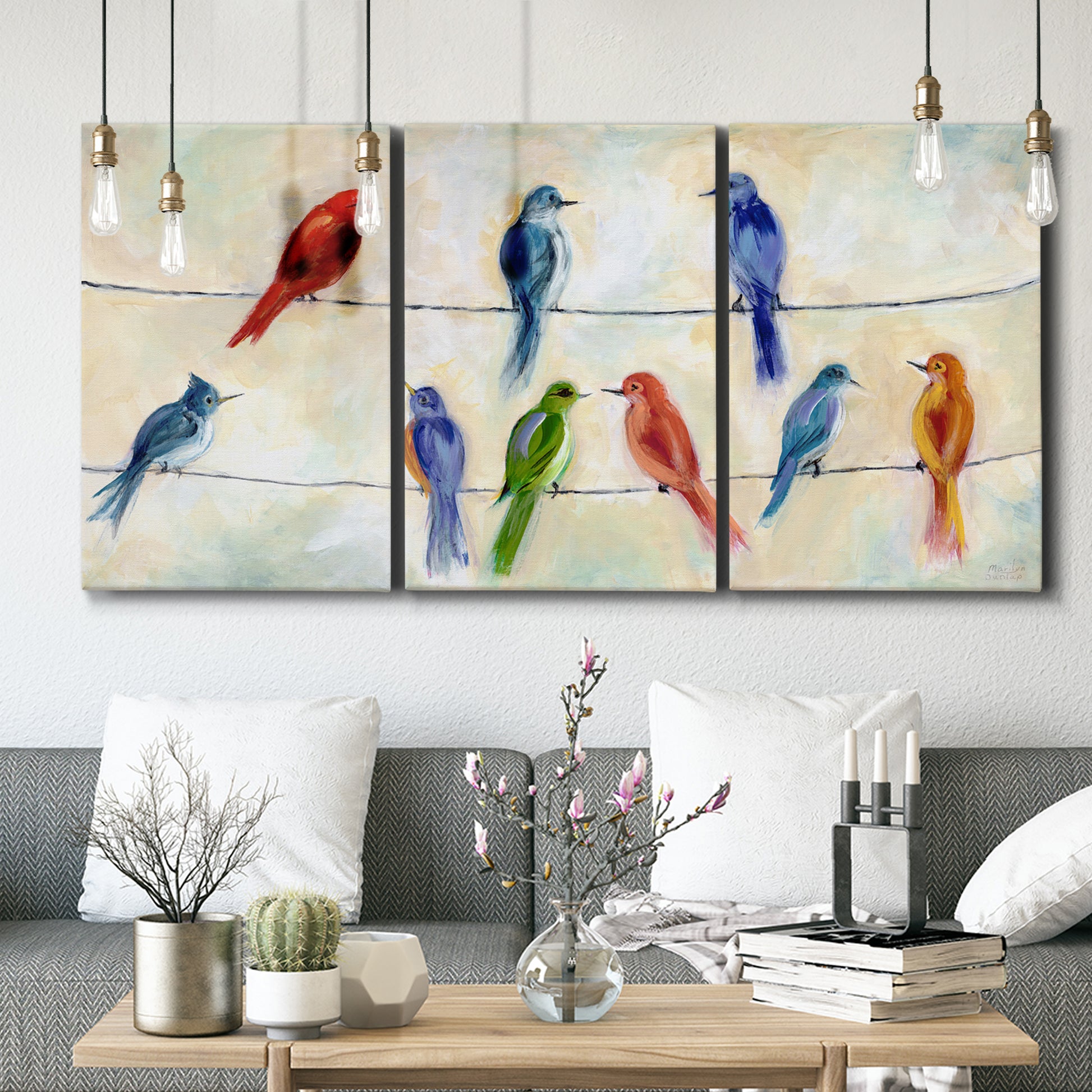 Three-panel canvas wall art featuring whimsical animal chatter illustration, displayed in a modern living room above seating.