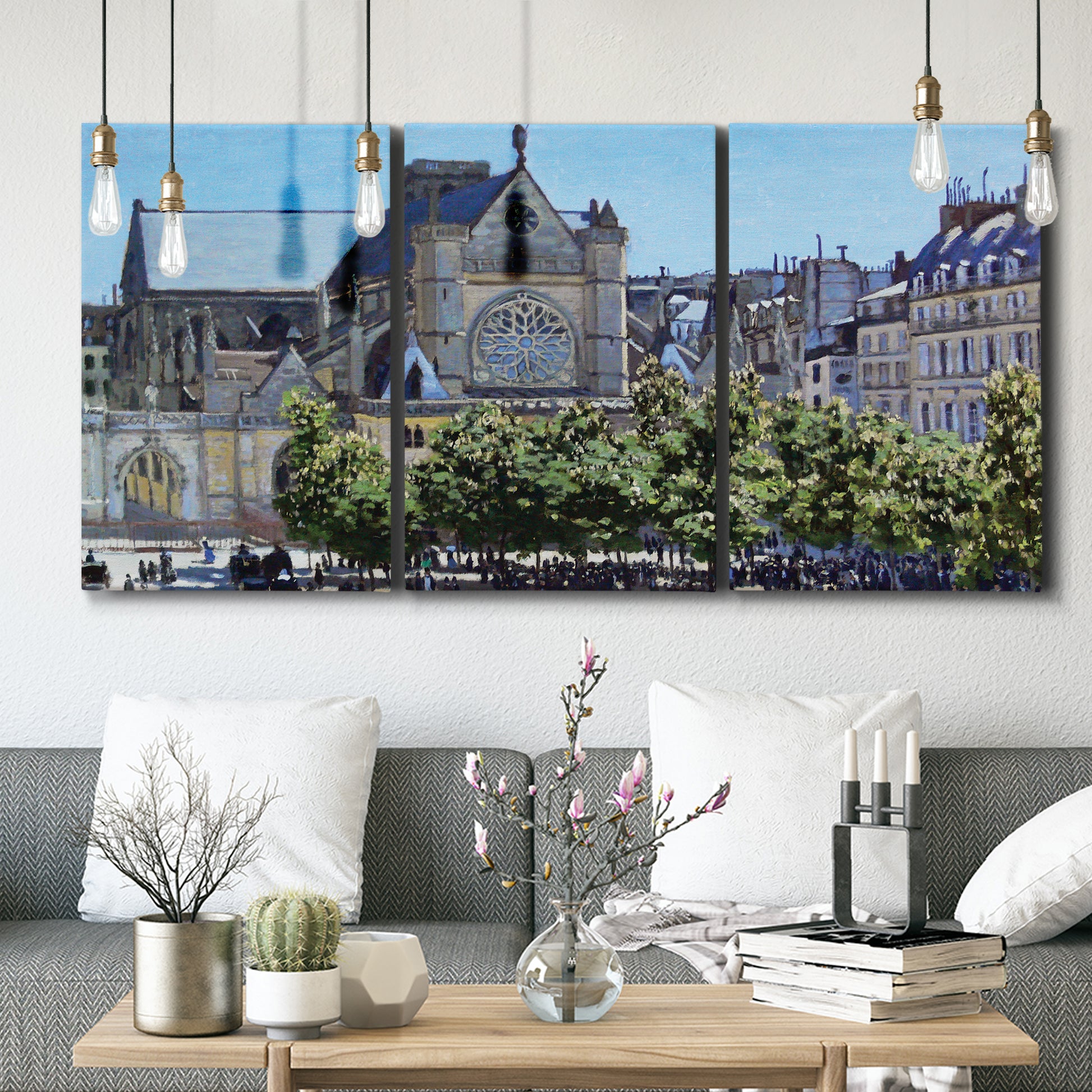 Three-panel canvas wall art featuring gothic church within city setting, displayed in a modern living room above seating.