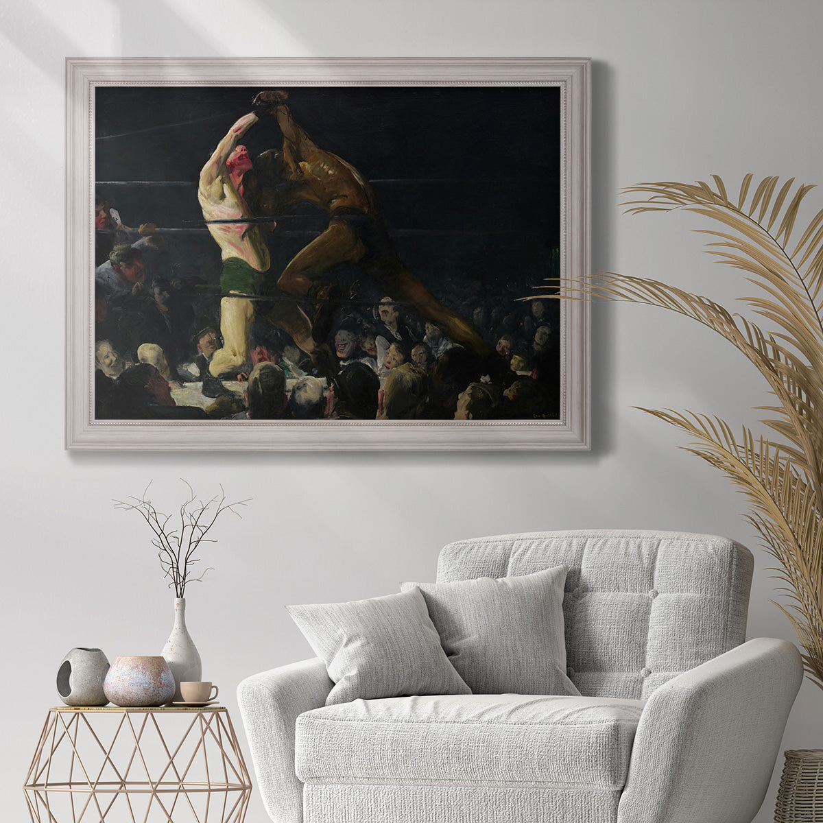 American genre painting of men in a social club by George Bellows in an ornate weathered white frame displayed in a bright interior setting.