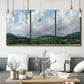 Three-panel canvas wall art featuring pastoral mountain landscape in blue, displayed in a modern living room above seating.