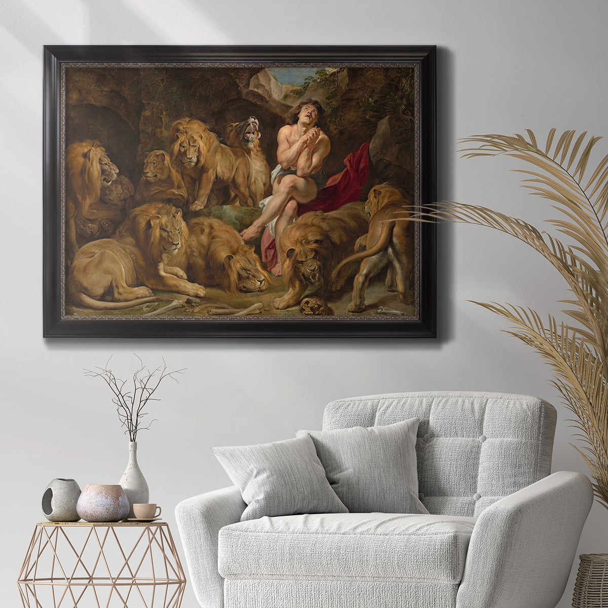 Dramatic biblical painting of Daniel with lions by Peter Paul Rubens in an ornate black frame with gilded inner detail displayed in a bright interior setting.
