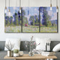 Three-panel canvas wall art featuring poppy field near garden village, displayed in a modern living room above seating.