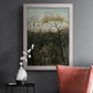 Dreamlike forest landscape scene by Henri Rousseau in an ornate weathered white frame displayed in a dark-toned interior setting.
