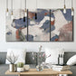 Three-panel canvas wall art featuring cool blue abstract layered composition, displayed in a modern living room above seating.