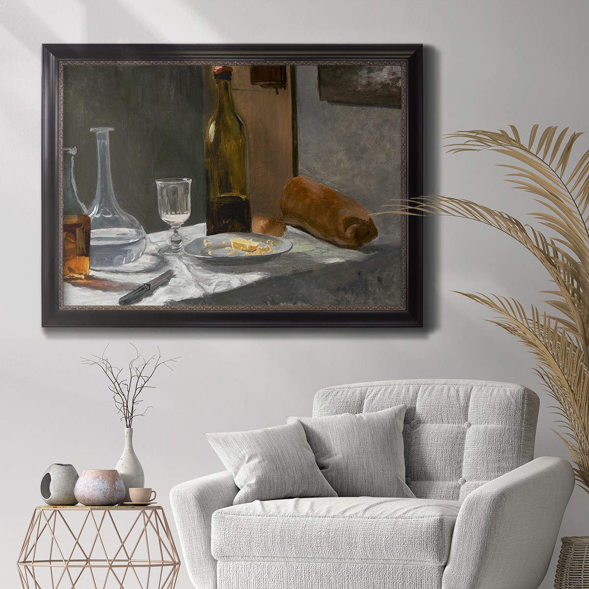 Impressionist still life with wine and bread by Claude Monet in an ornate black frame with gilded inner detail displayed in a bright interior setting.
